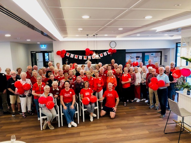 Large group of Samford Grove residents standing together wearing red for the Day for Daniel.